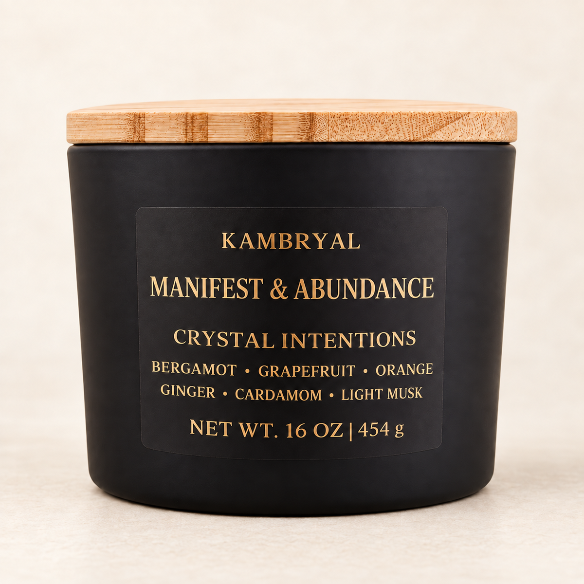 KAMBRYAL Manifest & Abundance 16 oz three wick candle in a matte black vessel with bamboo lid